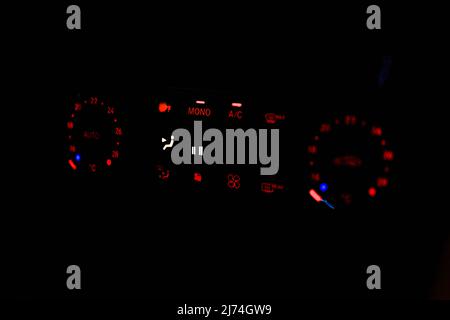 Close-up of the lights of the air conditioning control panel of a car at night Stock Photo