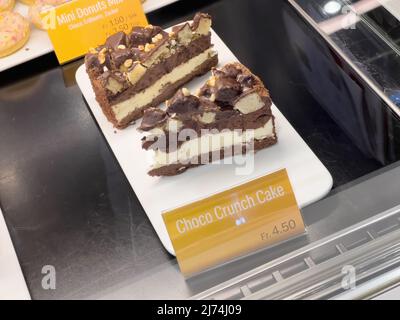 Basel, Switzerland - Dec 20, 2021: Close-up POV shot of delicious McDonalds Choco Crunch Cake with the high price of 4, 5 swiss francs Stock Photo