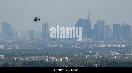 01 May 2022, Hessen, Frankfurt/Main: Cycling: UCI WorldTour - Eschborn - Frankfurt (185 km). A helicopter for the TV broadcast flies in front of the skyline Photo: Sebastian Gollnow/dpa Stock Photo