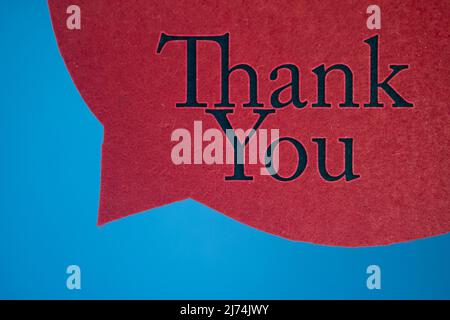 Speech bubble in front of colored background with Thank You text. Stock Photo