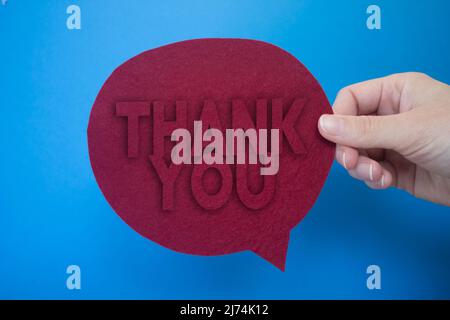 Speech bubble in front of colored background with Thank You text. Stock Photo