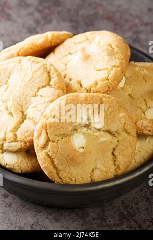 Shortbread cookies with macadamia nuts and white chocolate close-up. Vertical Stock Photo