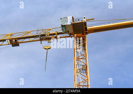 Basel, Switzerland - April 2022: View from below a tower crane on a construction site in the centre of Basel Stock Photo