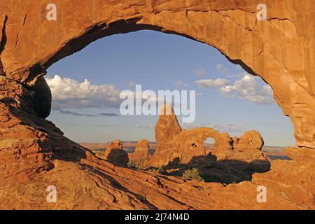View through North Window onto Turret Arch at sunrise, USA, Utah, Arches National Park Stock Photo