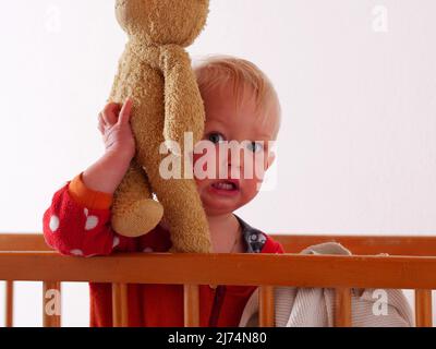 little girl is crying in bed Stock Photo