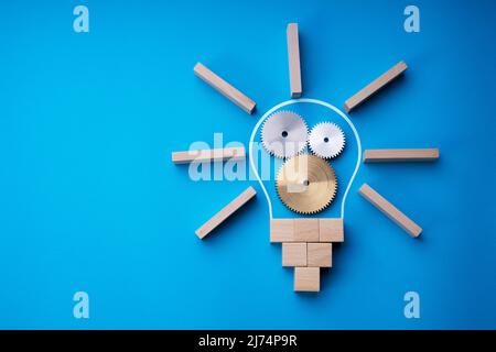 Lightbulb Invention Strategy. Gear Wheel Collaboration And Abstract Lamp Stock Photo