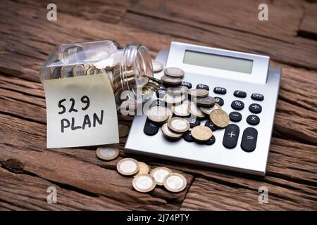529 Note Showing College Saving Plan And Coin Jar Stock Photo