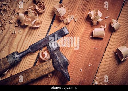 Hammer and chisel carpenter tool on wooden background Stock Photo