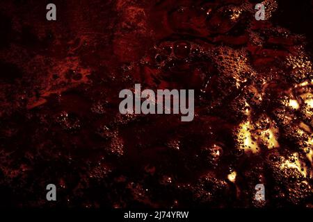 Abstract black and yellow background with bubbles. Black liquid surface with bubbles. Stock Photo