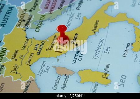 Italy location on map with red thumbtack, Europe travel idea, Rome and Italy on map with a red fastener, vacation and road trip concept, pinned Stock Photo