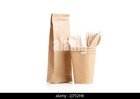Paper cups and paper bag made of eco kraft paper. Wooden cutlery set. Recycling concept. Zero waste. Stock Photo