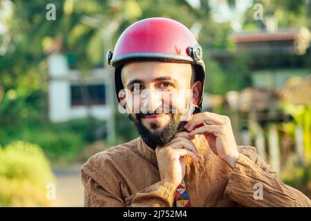 indian man wear helmet and ready to driving explore india attractions of Goa Stock Photo