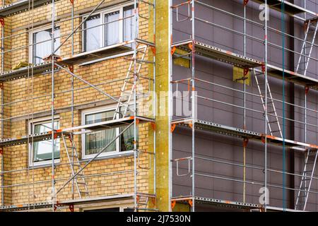 Insulation of the building with mineral wool outside. Protection of the house from the cold, noise insulation. Renovation of a multistory building. Stock Photo