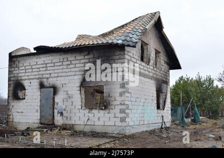 Myla village, Kyiv region, Ukraine - April 03, 2022: Private house burned out by the russian occupiers in the result of shelling. Stock Photo