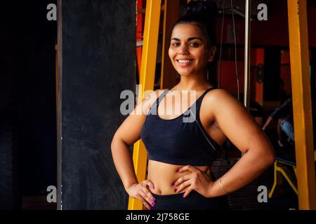 happy hispanic latin american woman holding hands on the waist proudly looking at camera Stock Photo