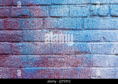 Colorful painted brick wall in city alley. Stock Photo