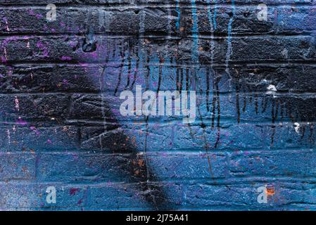 Colorful painted brick wall in city alley. Stock Photo