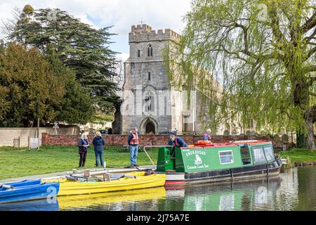 The Cotswold Canals Trust long boat Endeavour on the restored Stroudwater Canal at St Cyr's Church, Stonehouse, Gloucestershire, England UK Stock Photo