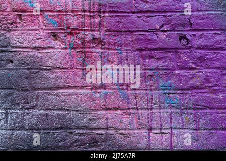 Colorful painted brick wall in city alley. Stock Photo