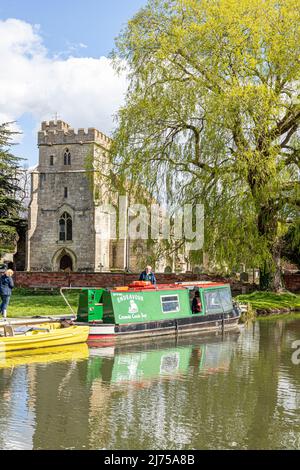 The Cotswold Canals Trust long boat Endeavour on the restored Stroudwater Canal at St Cyr's Church, Stonehouse, Gloucestershire, England UK Stock Photo