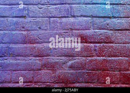 Colorful painted brick wall in city alley. Stock Photo