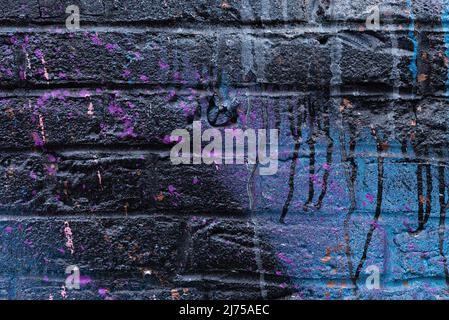 Colorful painted brick wall in city alley. Stock Photo
