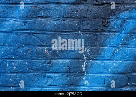 Colorful painted brick wall in city alley. Stock Photo