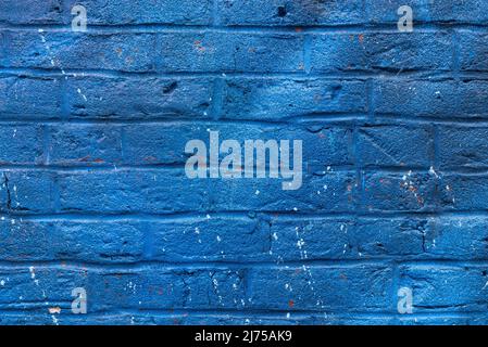 Colorful painted brick wall in city alley. Stock Photo