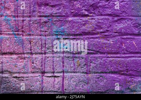 Colorful painted brick wall in city alley. Stock Photo
