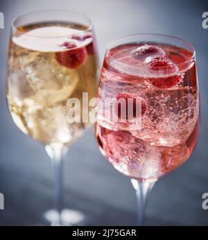 Two summer wine cocktails with raspberries