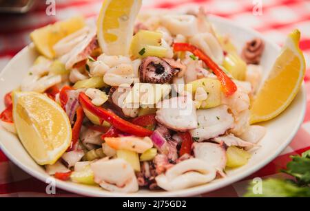 Seafood salad with lemon wedges Stock Photo