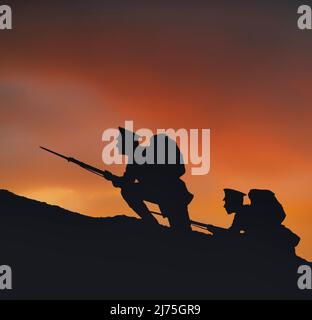Two soldiers on a dawn raid with rifles and fixed bayonets. Silhouetted against a reddening sky, they climb a hill on the frontline during  World War One, 1914-1918. Stock Photo