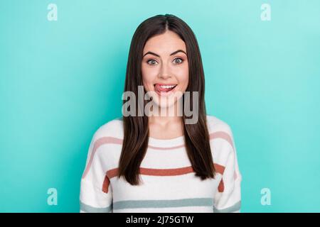 Photo of excited tricky lady dressed striped pullover smiling sticking out isolated teal color background Stock Photo