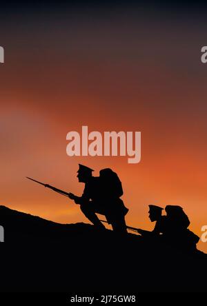 Two soldiers on a dawn raid with rifles and fixed bayonets. Silhouetted against a reddening sky, they climb a hill on the frontline during  World War One, 1914-1918. Stock Photo
