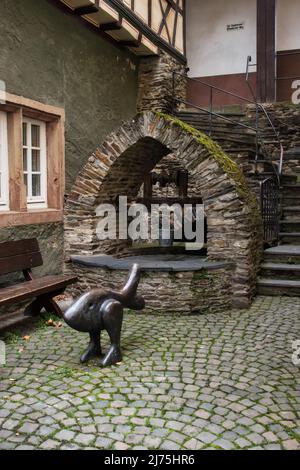 Statue in front of a well in the small town of Bacharach, Germany on a fall day. Stock Photo