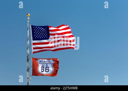 Elk City, Oklahoma - Flags on historic U.S. Route 66. Established in 1926, Route 66 ran from Chicago to Los Angeles. It was later replaced by Intersta Stock Photo