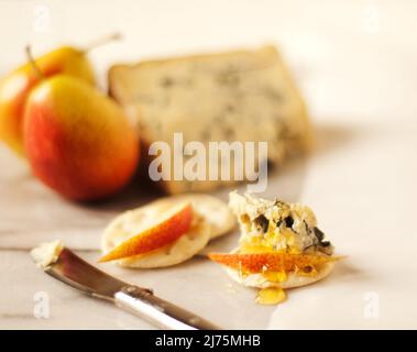 Crackers with blue cheese, pear slices and honey Stock Photo