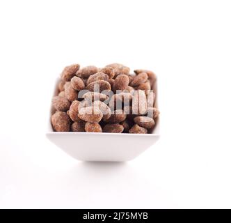 Bowl of Candied Almonds on a White Background Stock Photo