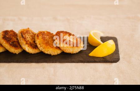 Crab Cakes on Slate with Lemon Stock Photo