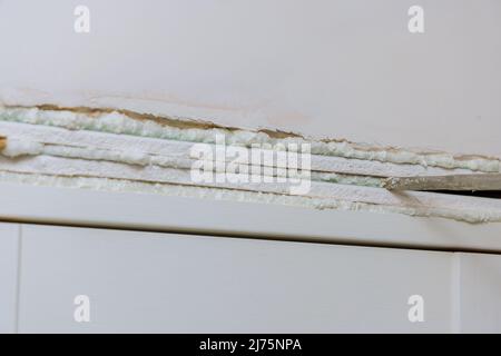 Renovation of old apartment with installation of wooden doors using polyurethane foam to mounting Stock Photo