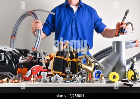 Sample of plumbing materials and tools on workbench and white isolated background. Front view. Horizontal composition. Stock Photo