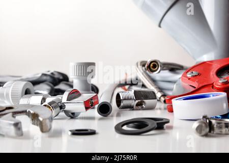 Sample of plumbing materials and tools on white. Front view. Horizontal composition. Stock Photo