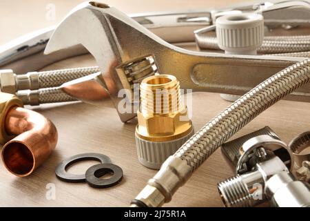 Plumbing background detail with tools and materials on white table. Top view. Horizontal composition. Stock Photo