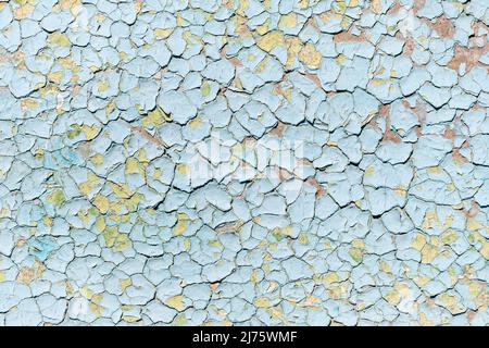 Blue old faded cracked painted surface pattern on building exterior interior wall with aged scratched paint layers. Abstract old plaster stucco Stock Photo