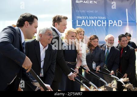 Boca Chica, Texas USA 22SEP14: ELON MUSK  (third from left), SpaceX CEO and co-founder, helps break ground on the Boca Chica, Texas site of the new SpaceX space port in far south Texas. Next to Musk is Gwynne Shotwell, SpaceX president and chief operating officer (fourth from left.) The remote site east of Brownsville, Texas is two miles from the mouth of the Rio Grande River and Texas' border with Mexico. ©Bob Daemmrich Stock Photo