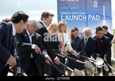 Boca Chica, Texas USA 22SEP14: ELON MUSK  (third from left), SpaceX CEO and co-founder, helps break ground on the Boca Chica, Texas site of the new SpaceX space port in far south Texas. Next to Musk is Gwynne Shotwell, SpaceX president and chief operating officer (fourth from left.) The remote site east of Brownsville, Texas is two miles from the mouth of the Rio Grande River and Texas' border with Mexico. ©Bob Daemmrich Stock Photo