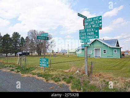 A road sign in the tiny village of Fort Rock, Oregon, pointing the way to various local attractions. Stock Photo