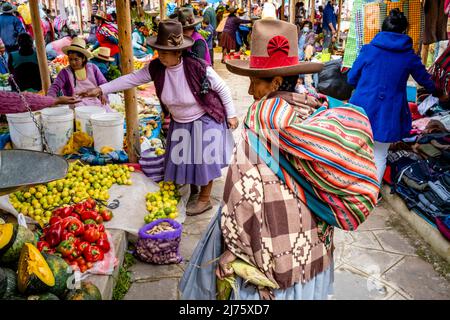 Senior Indigenous Quechua Women Shopping For Fruit and Vegetables At The Sunday Market In The Village Of Chinchero, Cusco Region, Peru. Stock Photo