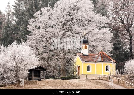 The small chapel near Krün in the Werdenfelser Land in hoarfrost in winter. Stock Photo