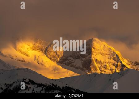 The footstone, at the foot of the olperer in the Tux Alps, glowing in the evening light from Maria Waldrast, seen in winter when there is snow. Stock Photo